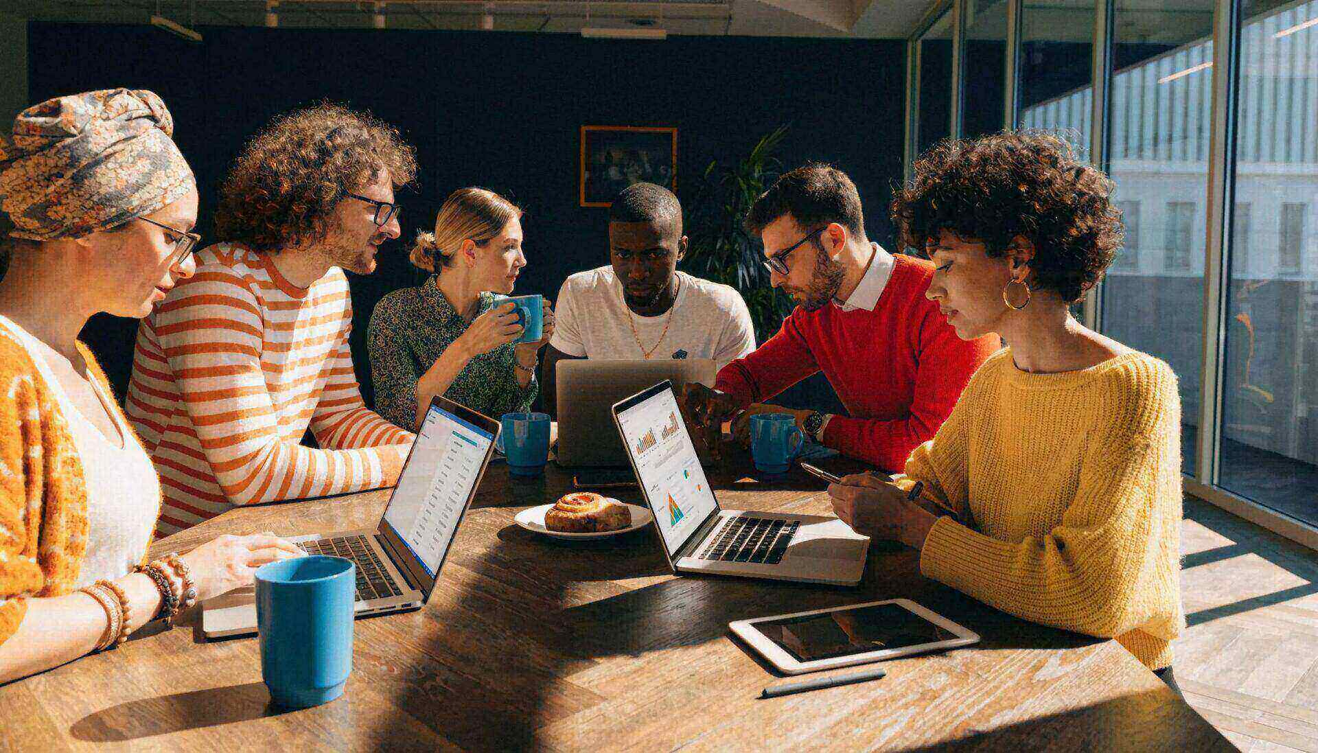 Group of marketers collaborating on Google Ads strategies, illustrating diverse audience targeting
